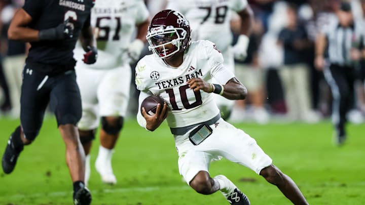 Nov 2, 2024; Columbia, South Carolina, USA; Texas A&M Aggies quarterback Marcel Reed (10) scrambles against the South Carolina Gamecocks in the second quarter at Williams-Brice Stadium. Mandatory Credit: Jeff Blake-Imagn Images