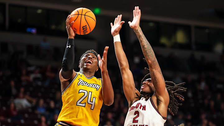 Nov 12, 2024; Columbia, South Carolina, USA; Towson Tigers guard Nendah Tarke (24) drives around South Carolina Gamecocks guard Zachary Davis (2) in the second half at Colonial Life Arena. Mandatory Credit: Jeff Blake-Imagn Images