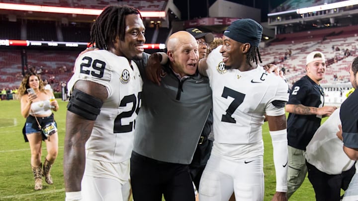 Sep 13, 2025; Columbia, South Carolina, USA; Vanderbilt Commodores head coach Clark Lea celebrates with edge Miles Capers (29) and safety Marlen Sewell (7) following their win over the South Carolina Gamecocks at Williams-Brice Stadium. Mandatory Credit: Jeff Blake-Imagn Images