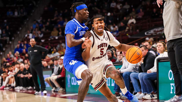 Feb 24, 2026; Columbia, South Carolina, USA; South Carolina Gamecocks guard Meechie Johnson (5) drives around Kentucky Wildcats guard Denzel Aberdeen (1) during the first half at Colonial Life Arena. Mandatory Credit: Jeff Blake-Imagn Images