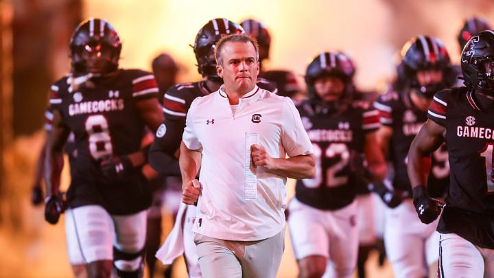 Sep 27, 2025; Columbia, South Carolina, USA; South Carolina Gamecocks head coach Shane Beamer leads his team onto the field during the Gamecocks 2001 entrance before their game against the Kentucky Wildcats at Williams-Brice Stadium. Mandatory Credit: Jeff Blake-Imagn Images