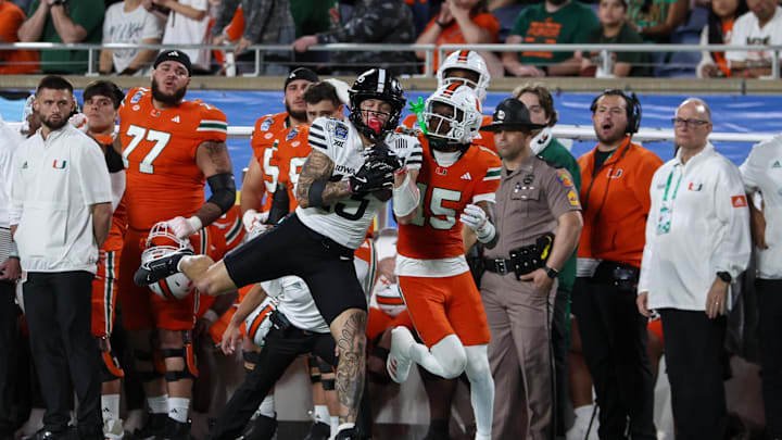 Dec 28, 2024; Orlando, FL, USA; Iowa State Cyclones wide receiver Jaylin Noel (13) receives a pass defended by Miami Hurricanes defensive back Markeith Williams (15) in the fourth quarter during the Pop Tarts bowl at Camping World Stadium. Mandatory Credit: Nathan Ray Seebeck-Imagn Images
