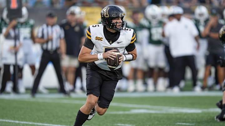 Aug 29, 2025; Charlotte, North Carolina, USA; Appalachian State Mountaineers quarterback AJ Swann (5) rolls out to pass against the Charlotte 49ers during the first quarter at Bank of America Stadium. Mandatory Credit: Jim Dedmon-Imagn Images Aug 29, 2025; Charlotte, North Carolina, USA; Appalachian State Mountaineers quarterback AJ Swann (5) rolls out to pass against the Charlotte 49ers during the first quarter at Bank of America Stadium. Mandatory Credit: Jim Dedmon-Imagn Images
