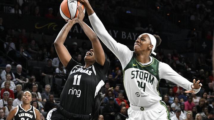 Sep 18, 2025; Las Vegas, Nevada, USA; Seattle Storm center Dominique Malonga (14) blocks a shot from Las Vegas Aces guard Dana Evans (11) in the first quarter during game three of round one for the 2025 WNBA Playoffs at Michelob Ultra Arena. Mandatory Credit: Candice Ward-Imagn Images