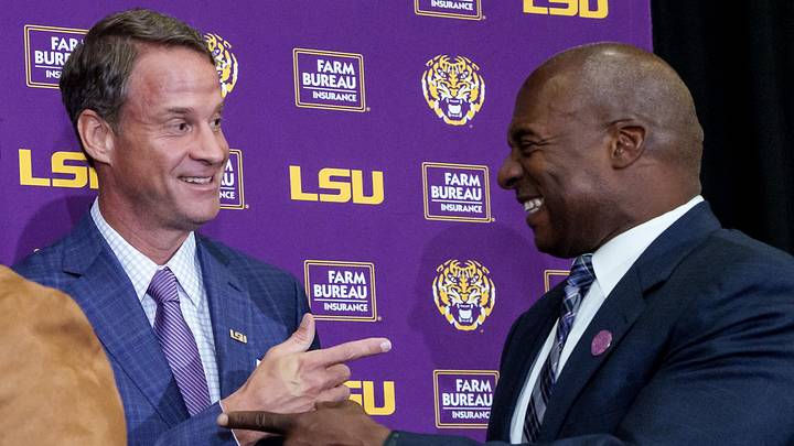 Dec 1, 2025; Baton Rouge, LA, USA; LSU new head coach Lane Kiffin, left, and LSU athletic director Verge Ausberry greet each other at South Stadium Club at Tiger Stadium. Mandatory Credit: Matthew Hinton-Imagn Images Dec 1, 2025; Baton Rouge, LA, USA; LSU new head coach Lane Kiffin, left, and LSU athletic director Verge Ausberry greet each other at South Stadium Club at Tiger Stadium. Mandatory Credit: Matthew Hinton-Imagn Images