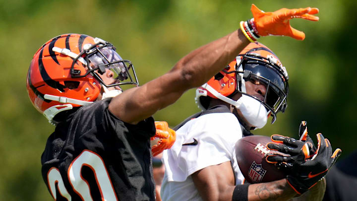 Cincinnati Bengals wide receiver Ja'Marr Chase (1) completes a catch down the sidelines as Cincinnati Bengals cornerback DJ Turner II (20) defends during NFL training camp practice, Monday, July 31, 2023, in Cincinnati.