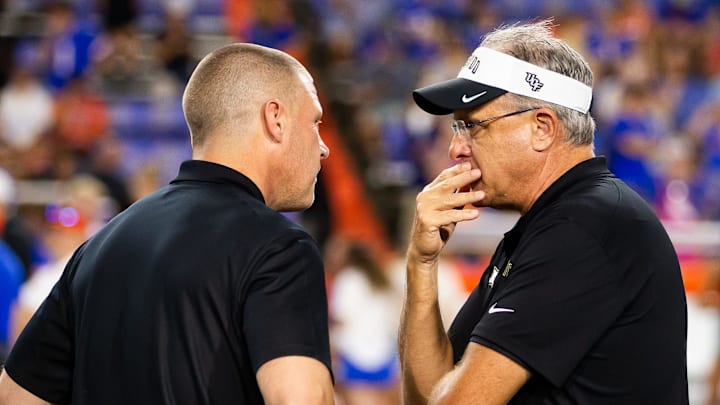 Florida Gators head coach Billy Napier, left, talks with UCF Knights head coach Gus Malzahn before rate start of the game at Ben Hill Griffin Stadium in Gainesville, FL on Saturday, October 5, 2024. [Doug Engle/Gainesville Sun]