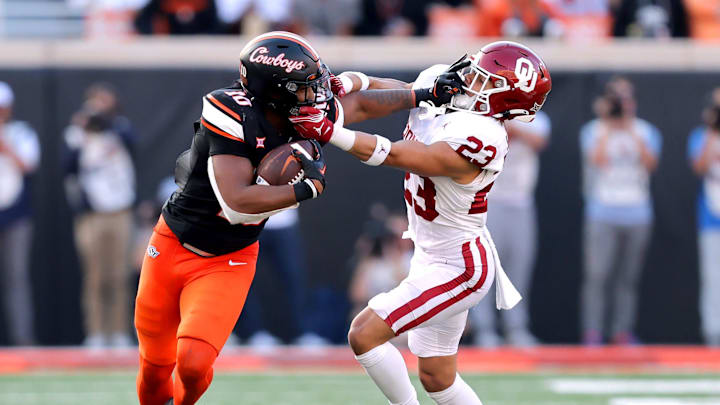 Oklahoma State's Rashod Owens (10) stiff arms Oklahoma's Jasiah Wagoner (23) during a Bedlam college football game between the Oklahoma State University Cowboys (OSU) and the University of Oklahoma Sooners (OU) at Boone Pickens Stadium in Stillwater, Okla., Saturday, Nov. 4, 2023. Oklahoma State's Rashod Owens (10) stiff arms Oklahoma's Jasiah Wagoner (23) during a Bedlam college football game between the Oklahoma State University Cowboys (OSU) and the University of Oklahoma Sooners (OU) at Boone Pickens Stadium in Stillwater, Okla., Saturday, Nov. 4, 2023.