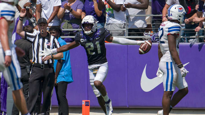Sep 23, 2023; Fort Worth, Texas, USA; TCU Horned Frogs safety Bud Clark (21) celebrates after he intercepts an SMU Mustangs pass during the second half at Amon G. Carter Stadium. Mandatory Credit: Jerome Miron-Imagn Images