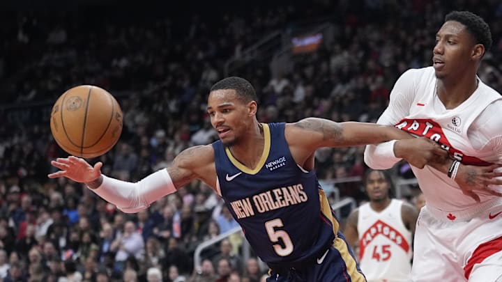 Jan 27, 2025; Toronto, Ontario, CAN; New Orleans Pelicans guard Dejounte Murray (5) goes after a rebound as Toronto Raptors guard RJ Barrett (9) tries to slow him up during the first half at Scotiabank Arena. Mandatory Credit: John E. Sokolowski-Imagn Images