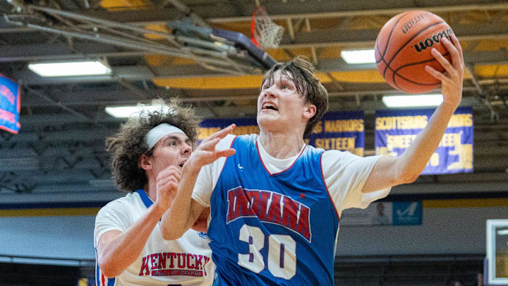 Indiana Junior All-Star Braylon Mullins (30) goes for a layup against Kentucky Junior All-Star Maddox Huff (8) during their game on Sunday, June 2, 2024 in Scottsburg, Ind. at Charles E. Meyer Gymnasium for the first game of the Indiana vs Kentucky All-Stars basketball week.