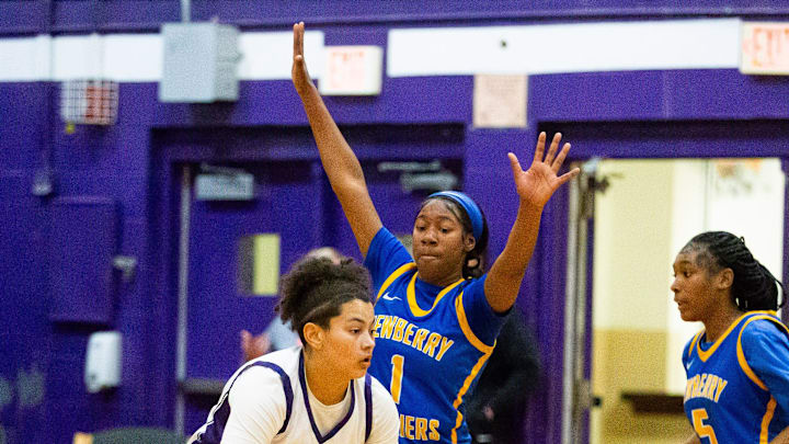 Newberry Panthers guard Brandy Whitfield (1) pressures Gainesville Hurricanes Jamison Cardwell (0) in the first half. The Gainesville Hurricanes hosted the Newberry Panthers at Gainesville High School in Gainesville, FL on Tuesday, December 3, 2024. The Hurricanes defeated the Panthers 67-41. [Doug Engle/Ocala Star Banner]