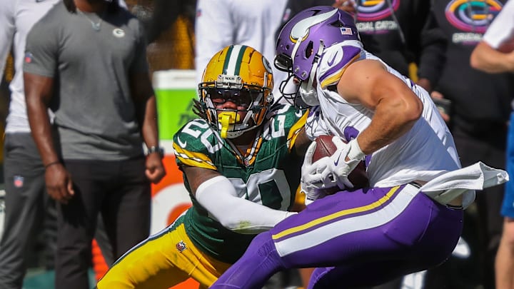 Green Bay Packers safety Javon Bullard (20) tries to tackle Minnesota Vikings tight end Johnny Mundt.