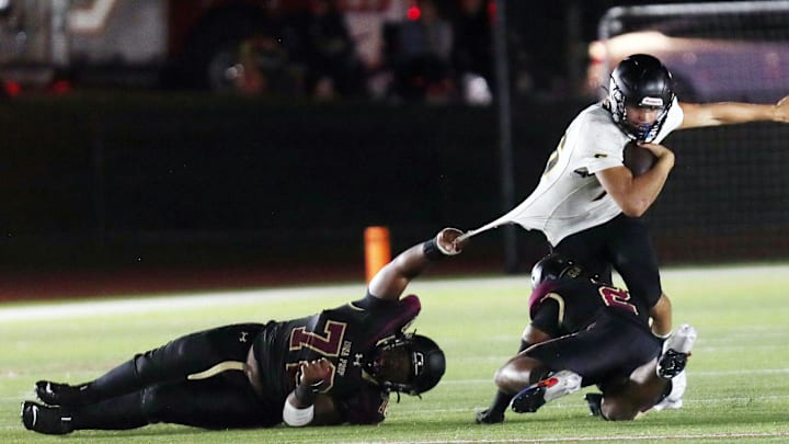 Ionas defenders look to stop Saint Anthony's quarterback Gary Merrill on a first half run during football action at Iona Prep. 