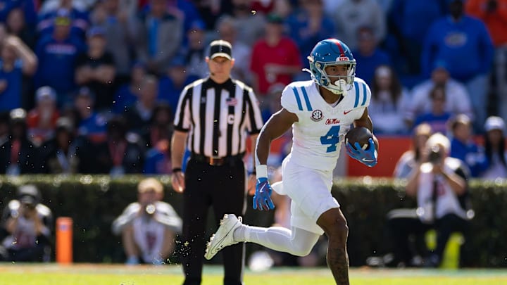 Nov 23, 2024; Gainesville, Florida, USA; Mississippi Rebels wide receiver Micah Davis (4) rushes with the ball against the Florida Gators during the first half at Ben Hill Griffin Stadium. Mandatory Credit: Matt Pendleton-Imagn Images