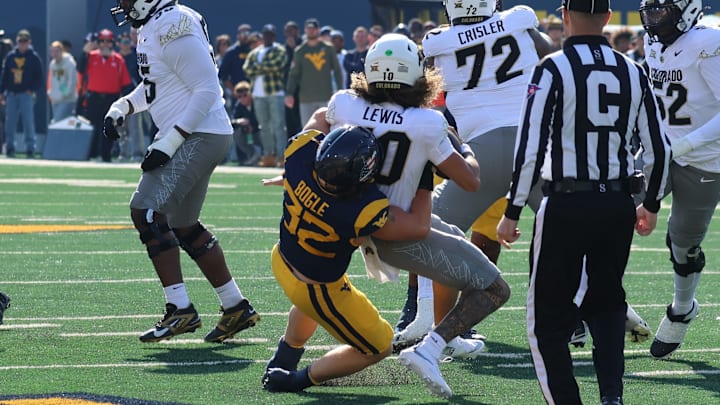 West Virginia University linebacker Ben Bogle sacks Colorado quarterback Julian Lewis. 