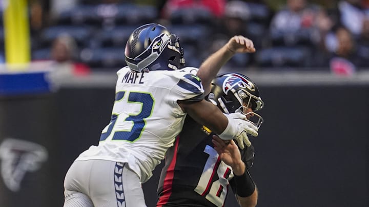 Oct 20, 2024; Atlanta, Georgia, USA; Seattle Seahawks linebacker Boye Mafe (53) hits Atlanta Falcons quarterback Kirk Cousins (18) causing a fumble that is returned for a Seahawks touchdown during the second half at Mercedes-Benz Stadium. Mandatory Credit: Dale Zanine-Imagn Images