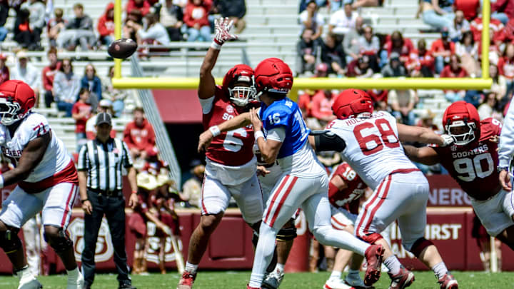 Oklahoma quarterback Whitt Newbauer throws as defensive lineman Nigel Smith gives pressure.