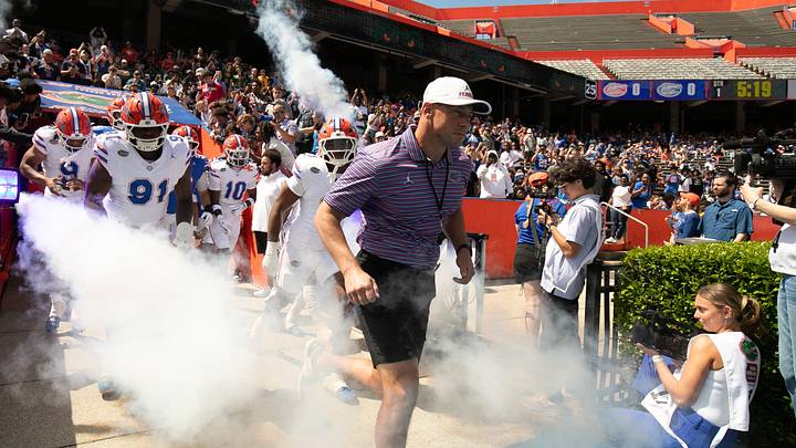 Florida head coach Jon Sumrall and the team blasts out onto the field before the Orange and Blue game at Steve Spurrier Field at Ben Hill Griffin Stadium in Gainesville, FL on Saturday, April 11, 2026. [Alan Youngblood/Gainesville Sun]