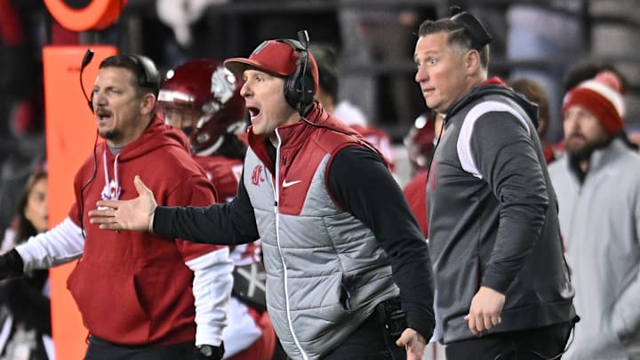 Nov 30, 2024; Pullman, Washington, USA; Washington State Cougars head coach Jake Dickert, center, reacts after a play against the Wyoming Cowboys in the second half at Gesa Field at Martin Stadium. Washington State Cougars won 15-14. Mandatory Credit: James Snook-Imagn Images
