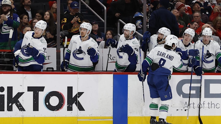 Jan 8, 2025; Washington, District of Columbia, USA; Vancouver Canucks right wing Conor Garland (8) celebrates with teammates after scoring a goal against the Washington Capitals in the second period at Capital One Arena. Mandatory Credit: Geoff Burke-Imagn Images
