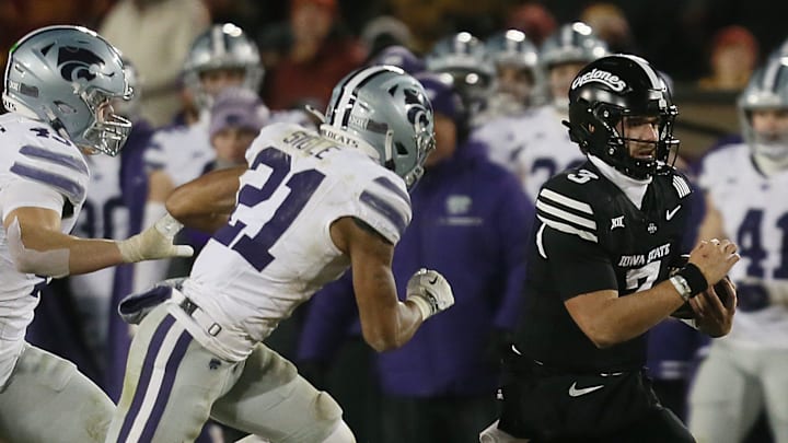 Iowa State Cyclones quarterback Rocco Becht (3) runs with the ball for a first down around Kansas State Wildcats safety Marques Sigle (21) and linebacker Austin Romaine (45) during the fourth quarter in the NCAA football at Jack Trice Stadium on Saturday, Nov. 30, 2024, in Ames, Iowa. Iowa State Cyclones quarterback Rocco Becht (3) runs with the ball for a first down around Kansas State Wildcats safety Marques Sigle (21) and linebacker Austin Romaine (45) during the fourth quarter in the NCAA football at Jack Trice Stadium on Saturday, Nov. 30, 2024, in Ames, Iowa.
