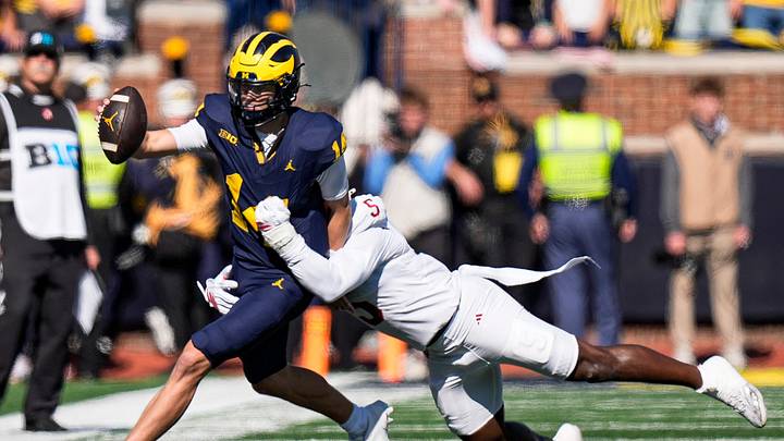 Michigan quarterback Tommy Carr (14) runs against Indiana linebacker Rolijah Hardy (5) during the first half at Michigan Stadium in Ann Arbor on Saturday, Oct. 24, 2026.
