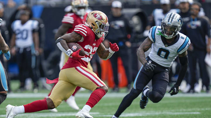Oct 9, 2022; Charlotte, North Carolina, USA; San Francisco 49ers running back Jeff Wilson Jr. (22) runs for yardage pursued by Carolina Panthers cornerback Jaycee Horn (8) during the first quarter at Bank of America Stadium. 