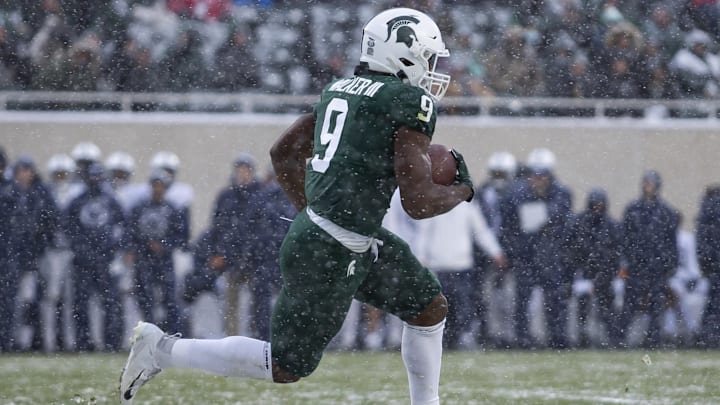 Nov 27, 2021; East Lansing, Michigan, USA; Michigan State Spartans running back Kenneth Walker III (9) runs the ball during the first quarter against the Penn State Nittany Lions at Spartan Stadium. Mandatory Credit: Raj Mehta-Imagn Images