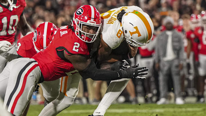 Nov 16, 2024; Athens, Georgia, USA; Tennessee Volunteers quarterback Nico Iamaleava (8) is tackled by Georgia Bulldogs linebacker Smael Mondon Jr. (2) during the first quarter at Sanford Stadium. Mandatory Credit: Dale Zanine-Imagn Images Nov 16, 2024; Athens, Georgia, USA; Tennessee Volunteers quarterback Nico Iamaleava (8) is tackled by Georgia Bulldogs linebacker Smael Mondon Jr. (2) during the first quarter at Sanford Stadium. Mandatory Credit: Dale Zanine-Imagn Images
