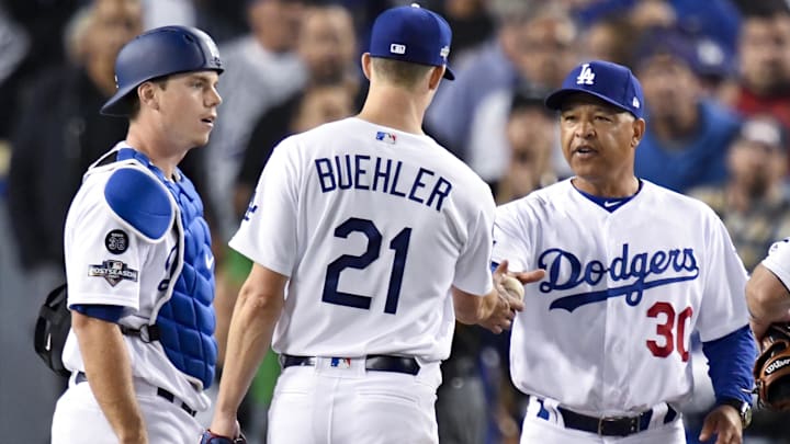 Oct 9, 2019; Los Angeles, CA, USA; Los Angeles Dodgers manager Dave Roberts (30) takes out starting pitcher Walker Buehler (21) during the seventh inning in game five of the 2019 NLDS playoff baseball series against the Washington Nationals at Dodger Stadium. Mandatory Credit: Robert Hanashiro-Imagn Images