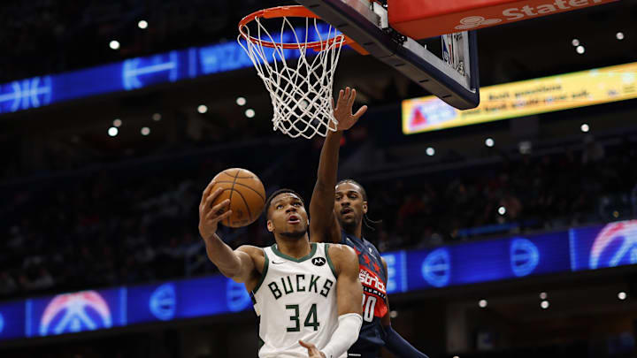 Feb 21, 2025; Washington, District of Columbia, USA; Milwaukee Bucks forward Giannis Antetokounmpo (34) shoots the ball as Washington Wizards forward Alex Sarr (20) defends in the first half at Capital One Arena. Mandatory Credit: Geoff Burke-Imagn Images