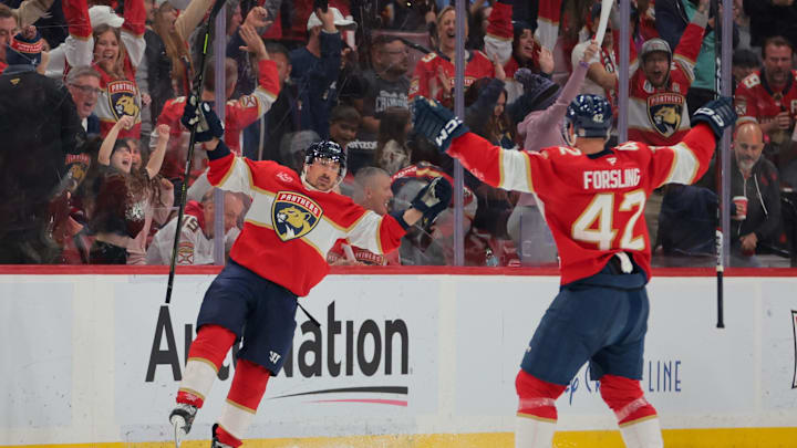 Apr 10, 2025; Sunrise, Florida, USA; Florida Panthers center Brad Marchand (63) celebrates with defenseman Gustav Forsling (42) after scoring against the Detroit Red Wings during the second period at Amerant Bank Arena. Mandatory Credit: Sam Navarro-Imagn Images
