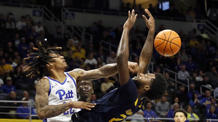 Nov 11, 2022; Pittsburgh, Pennsylvania, USA;  Pittsburgh Panthers guard Nike Sibande (22) fouls West Virginia Mountaineers guard Kobe Johnson (2) during the second half at the Petersen Events Center. West Virginia won 81-56. Mandatory Credit: Charles LeClaire-Imagn Images