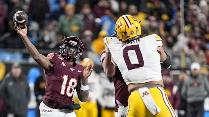 Jan 3, 2025; Charlotte, NC, USA; Virginia Tech Hokies quarterback William Watson III (18) makes a throw over Minnesota Golden Gophers defensive lineman Anthony Smith (0) during the second half at the Duke’s Mayo Bowl at Bank of America Stadium. Mandatory Credit: Jim Dedmon-Imagn Images