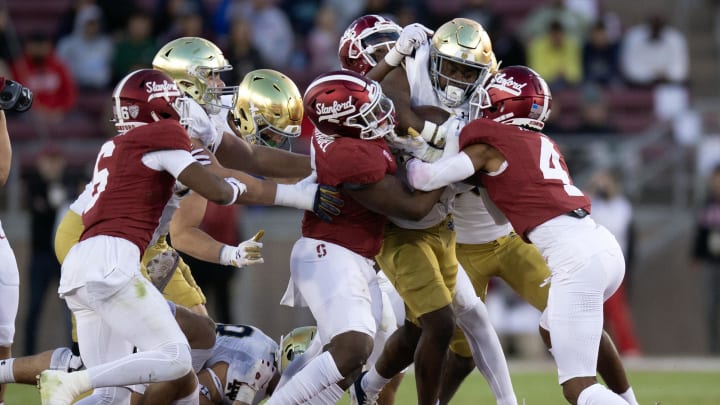 Nov 25, 2023; Stanford, California, USA; Notre Dame Fighting Irish running back Audric Estim (7) runs into a wall of Stanford Cardinal defenders during the first quarter at Stanford Stadium. Mandatory Credit: D. Ross Cameron-USA TODAY Sports Nov 25, 2023; Stanford, California, USA; Notre Dame Fighting Irish running back Audric Estim (7) runs into a wall of Stanford Cardinal defenders during the first quarter at Stanford Stadium. Mandatory Credit: D. Ross Cameron-USA TODAY Sports