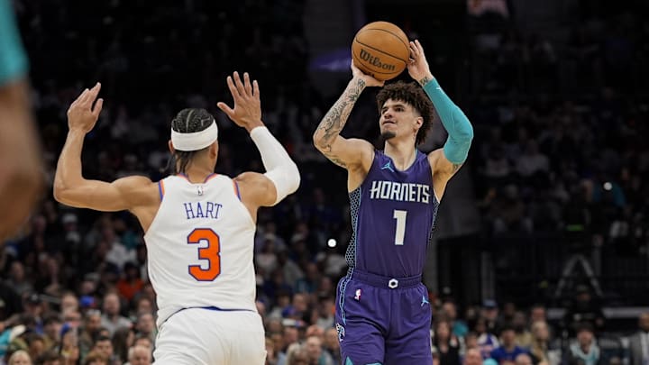 Mar 20, 2025; Charlotte, North Carolina, USA;Charlotte Hornets guard LaMelo Ball (1) shoots a three over New York Knicks guard Josh Hart (3) during the second half at Spectrum Center. Mandatory Credit: Jim Dedmon-Imagn Images