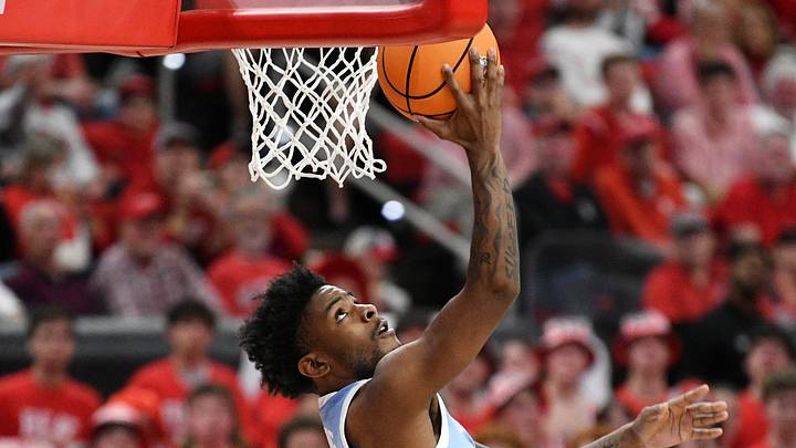 Feb 17, 2026; Raleigh, North Carolina, USA;  North Carolina Tar Heels guard Jaydon Young (4) lays the ball up for a basket against the NC State Wolfpack during the second half at Lenovo Center. Mandatory Credit: Zachary Taft-Imagn Images