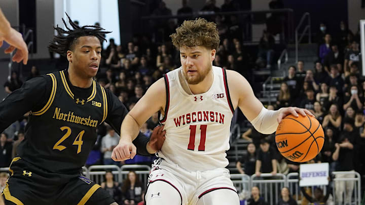 Feb 1, 2025; Evanston, Illinois, USA; Northwestern Wildcats guard K.J. Windham (24) defends Wisconsin Badgers guard Max Klesmit (11) during the first half at Welsh-Ryan Arena. Mandatory Credit: David Banks-Imagn Images