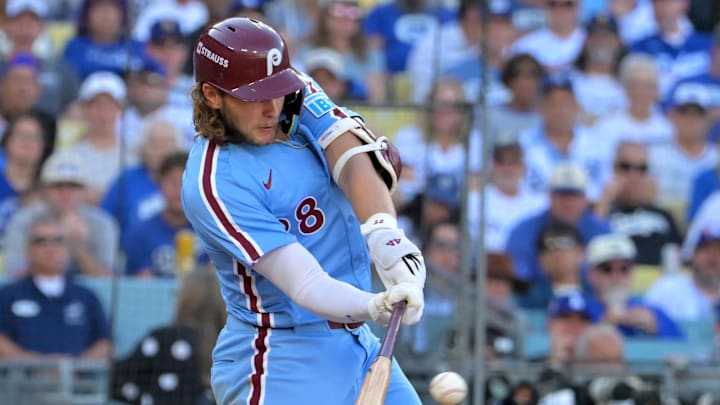Oct 9, 2025; Los Angeles, California, USA; Philadelphia Phillies third baseman Alec Bohm (28) singles in the sixth inning against the Los Angeles Dodgers during game four of the NLDS round for the 2025 MLB playoffs at Dodger Stadium. Mandatory Credit: Jayne Kamin-Oncea-Imagn Images