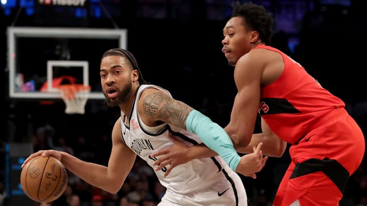 Mar 26, 2025; Brooklyn, New York, USA; Brooklyn Nets forward Trendon Watford (9) controls the ball against Toronto Raptors forward Scottie Barnes (4) during the first quarter at Barclays Center. Mandatory Credit: Brad Penner-Imagn Images