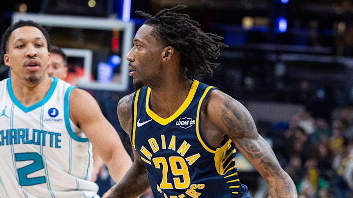 Feb 26, 2026; Indianapolis, Indiana, USA;  Indiana Pacers guard Quenton Jackson (29) dribbles the ball while Charlotte Hornets forward Grant Williams (2) defends in the second  half at Gainbridge Fieldhouse. Mandatory Credit: Trevor Ruszkowski-Imagn Images