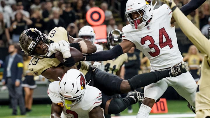 Sep 7, 2025; New Orleans, Louisiana, USA; New Orleans Saints tight end Juwan Johnson (83) grabs a pass in the end zone but Arizona Cardinals safety Jalen Thompson (34) knocks the ball loose in for an incomplete pass during the fourth quarter at Caesars Superdome. Mandatory Credit: Matthew Hinton-Imagn Images Sep 7, 2025; New Orleans, Louisiana, USA; New Orleans Saints tight end Juwan Johnson (83) grabs a pass in the end zone but Arizona Cardinals safety Jalen Thompson (34) knocks the ball loose in for an incomplete pass during the fourth quarter at Caesars Superdome. Mandatory Credit: Matthew Hinton-Imagn Images