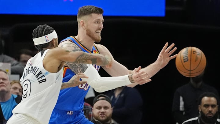 Feb 13, 2025; Minneapolis, Minnesota, USA; Oklahoma City Thunder center Isaiah Hartenstein (55) passes the ball as Minnesota Timberwolves forward Nickeil Alexander-Walker (9) defends him in the third quarter at Target Center. Mandatory Credit: Bruce Kluckhohn-Imagn Images