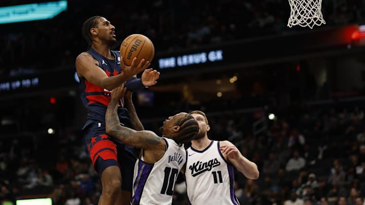Apr 2, 2025; Washington, District of Columbia, USA; Washington Wizards forward Alex Sarr (20) fouls Sacramento Kings forward DeMar DeRozan (10) while shooting the ball in the second half at Capital One Arena. Mandatory Credit: Geoff Burke-Imagn Images