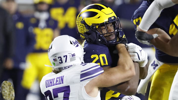Nov 23, 2024; Ann Arbor, Michigan, USA;  Michigan Wolverines running back Kalel Mullings (20) is tackled by Northwestern Wildcats linebacker Mac Uihlein (37) in the second half at Michigan Stadium. Mandatory Credit: Rick Osentoski-Imagn Images