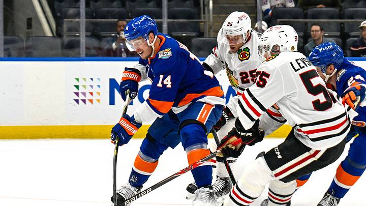 Oct 8, 2026; Elmont, New York, USA;  New York Islanders center Bo Horvat (14) attempts a shot defended by Chicago Blackhawks defenseman Artyom Levshunov (55) and Chicago Blackhawks center Dominic Toninato (25) during the second period at UBS Arena.  Mandatory Credit: Dennis Schneidler-Imagn Images