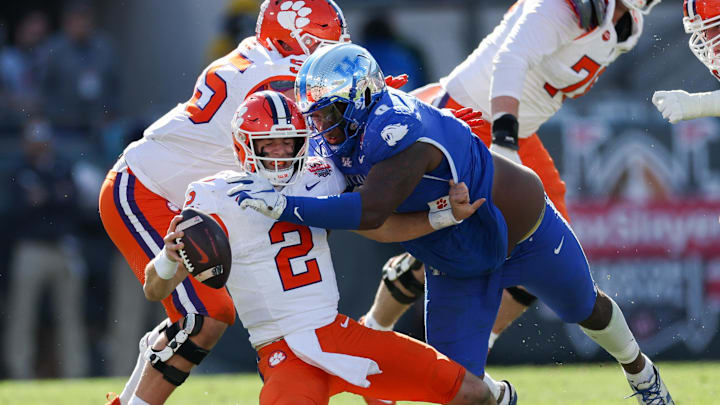 Dec 29, 2023; Jacksonville, FL, USA; Clemson Tigers quarterback Cade Klubnik (2) is brought down by Kentucky Wildcats defensive lineman Deone Walker (0) in the third quarter during the Gator Bowl at EverBank Stadium Dec 29, 2023; Jacksonville, FL, USA; Clemson Tigers quarterback Cade Klubnik (2) is brought down by Kentucky Wildcats defensive lineman Deone Walker (0) in the third quarter during the Gator Bowl at EverBank Stadium