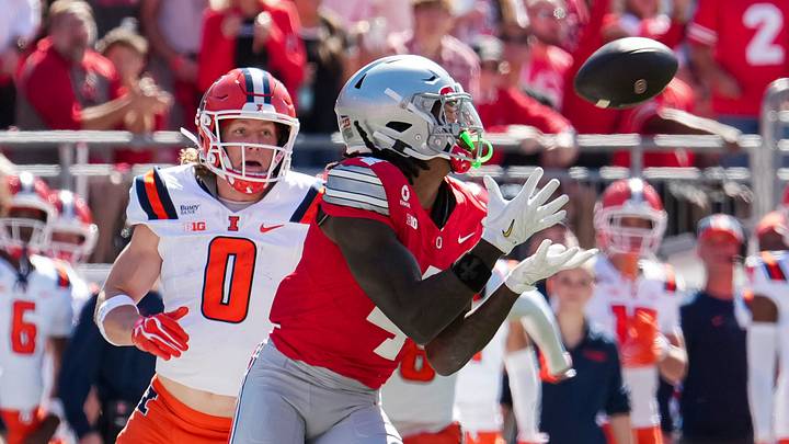 Ohio State Buckeyes wide receiver Jeremiah Smith (4) catches a pass in front of Illinois Fighting Illini defensive back Mac Resetich (0) during the NCAA football game at Ohio Stadium in Columbus on Sept. 26, 2026. Ohio State Buckeyes wide receiver Jeremiah Smith (4) catches a pass in front of Illinois Fighting Illini defensive back Mac Resetich (0) during the NCAA football game at Ohio Stadium in Columbus on Sept. 26, 2026.