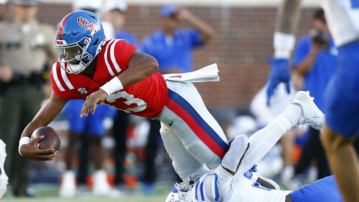 Sep 7, 2024; Oxford, Mississippi, USA; Mississippi Rebels quarterback Austin Simmons (13) dives forward as he is tackled by Middle Tennessee Blue Raiders defensive back Rickey Smith (27) during the second half at Vaught-Hemingway Stadium. Mandatory Credit: Petre Thomas-Imagn Images